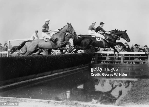 Rest Assured ridden by jockey George Archibald Jr leads Tommy Carey on Agleam over the water jump fence during the National Hunt Moderate Chase on...