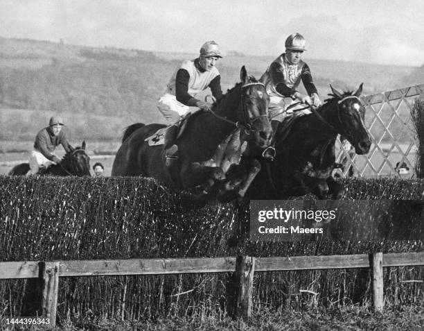 Kipper Kite ridden by jockey Bob Turnell jumps the last fence alongside Bobby O'Ryan on Clare Man during the Cheltenham Handicap Steeplechase on 20th...