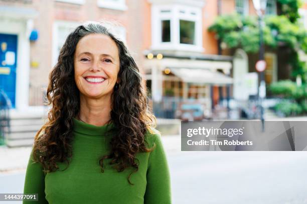 portrait of woman looking at camera, smiling - headshots for testimonial stock-fotos und bilder