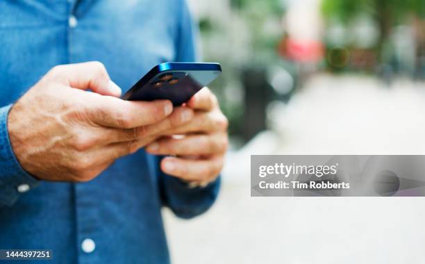 close up of man using smart phone - text ストックフォトと画像