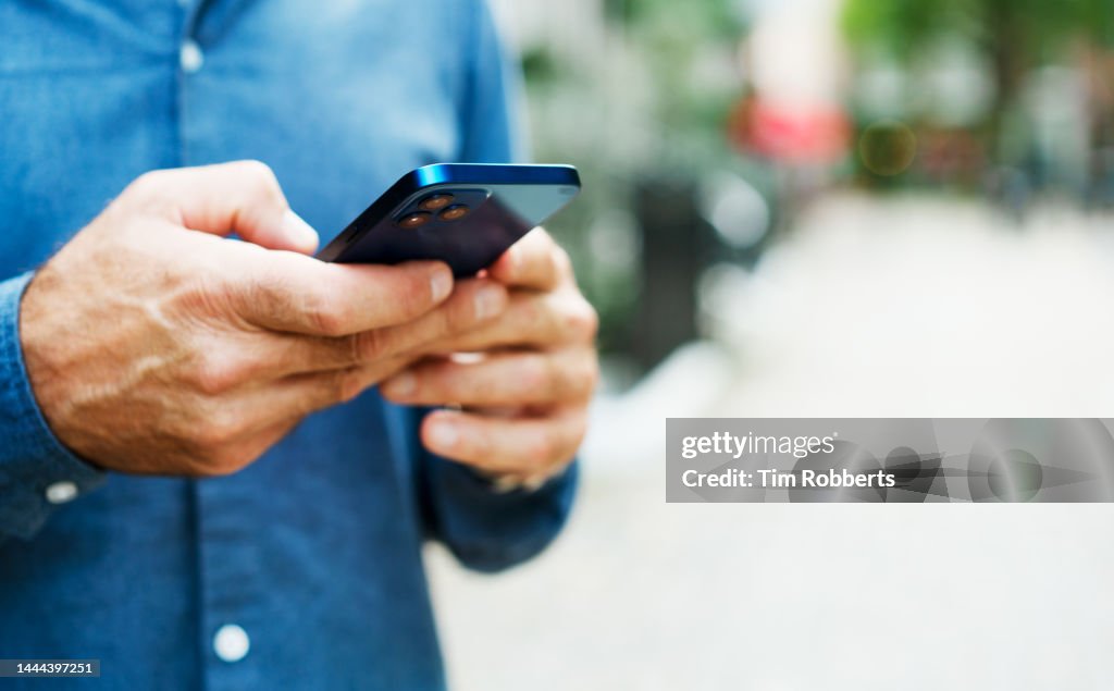 Close up of man using smart phone