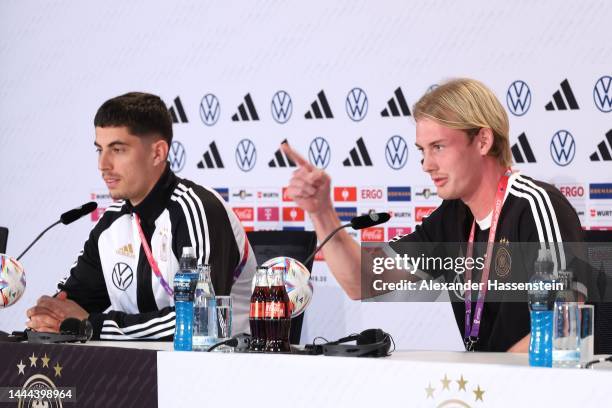 Julian Brandt of Germany speaks to the media next to his team mate Kai Havertz during the Germany press conference at DFB Media Centre Al Shamal...