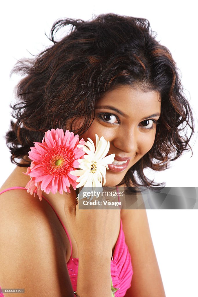 A portrait of a young woman holding a flower