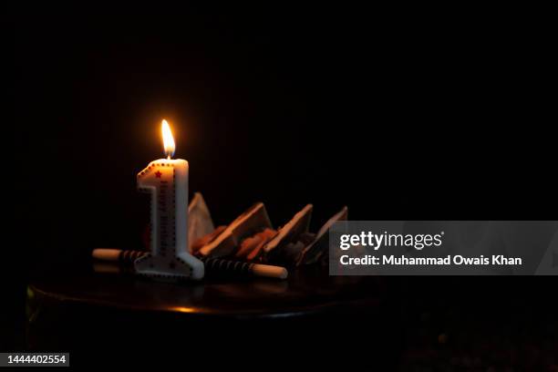 cake with number 1 candle - birthday candle on black stock pictures, royalty-free photos & images