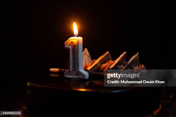 cake with number 1 candle - birthday candle on black stock pictures, royalty-free photos & images
