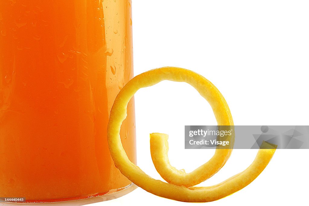 A glass of orange juice, partial view