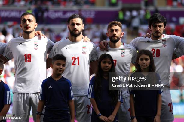 Majid Hosseini, Ahmad Noorollahi, Ali Gholizadeh and Sardar Azmoun of IR Iran line up for the national anthem prior to the FIFA World Cup Qatar 2022...