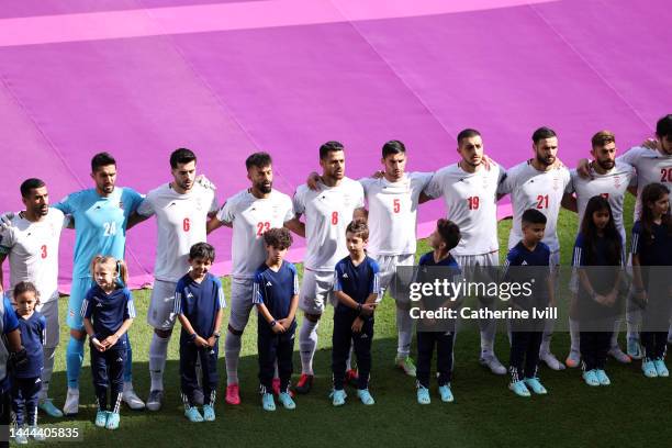 Iran players line up for the national anthem prior to the FIFA World Cup Qatar 2022 Group B match between Wales and IR Iran at Ahmad Bin Ali Stadium...