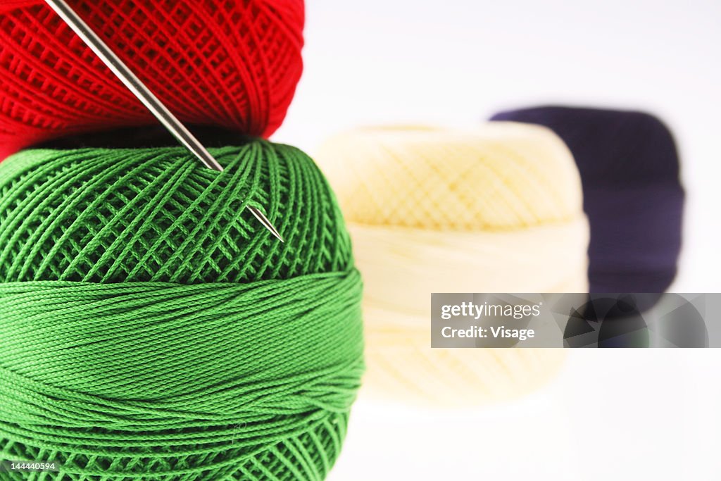 Close up of thread spools with a needle