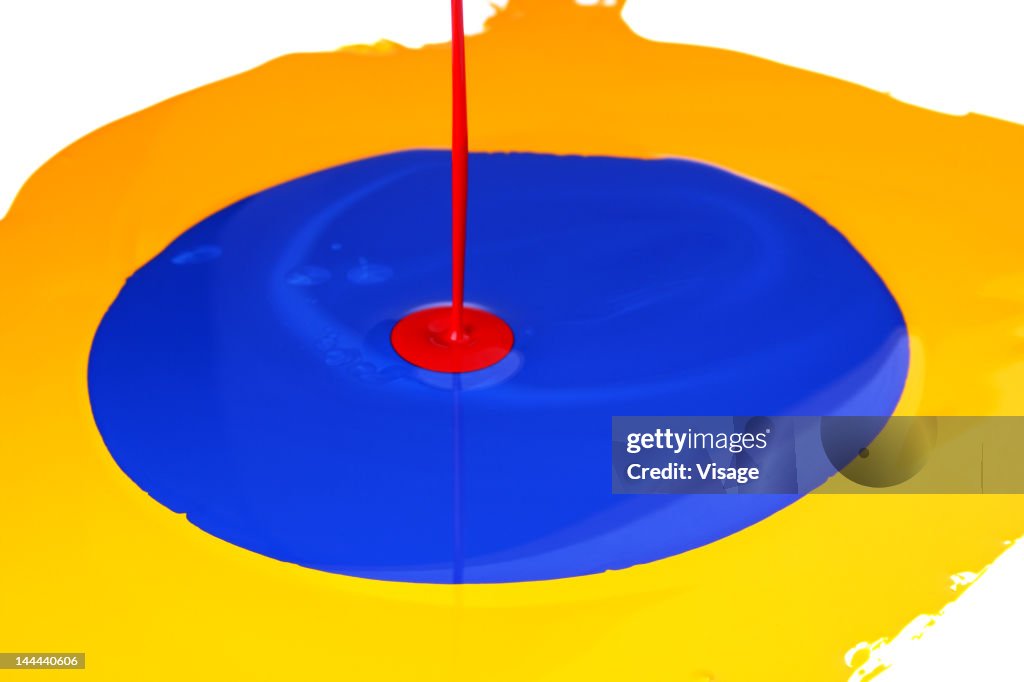 Studio shot of yellow, blue and red paint