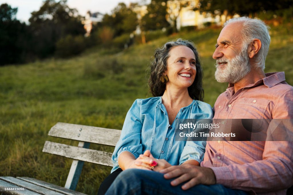Man and woman on bench, smiling