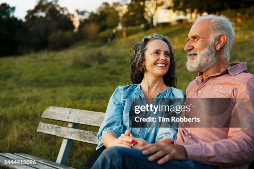 Man and woman on bench, smiling Man and woman on bench, smiling