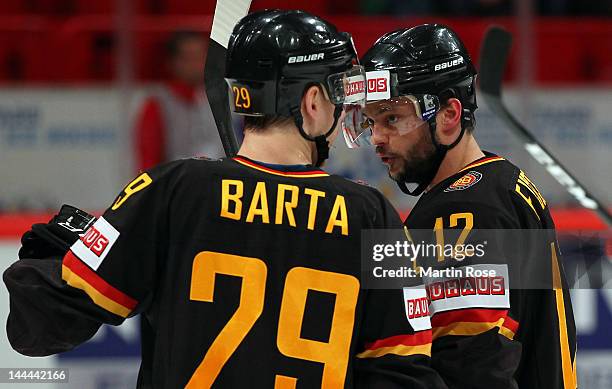 Christopher Fischer of Germany talks to team mate Alex Barta during the IIHF World Championship group S match between Germany and Norway at Ericsson...