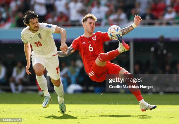 Joe Rodon of Wales controls the ball against Sardar Azmoun of IR Iran during the FIFA World Cup Qatar 2022 Group B match between Wales and IR Iran at...