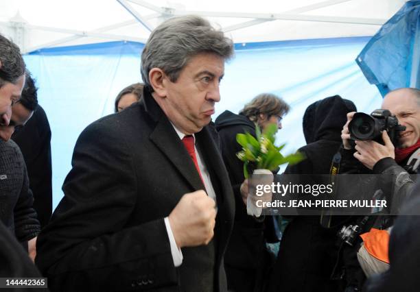 French Front de Gauche leftist party's candidate for the 2012 French presidential election, Jean-Luc Melenchon gestures in front of press...