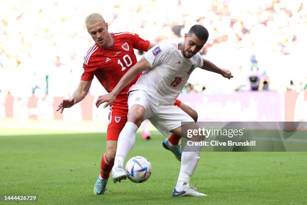 Majid Hosseini of IR Iran controls the ball against Aaron Ramsey of Wales during the FIFA World Cup Qatar 2022 Group B match between Wales and IR...