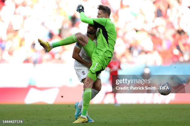 Mehdi Taremi of IR Iran is fouled by Wayne Hennessey of Wales during the FIFA World Cup Qatar 2022 Group B match between Wales and IR Iran at Ahmad...