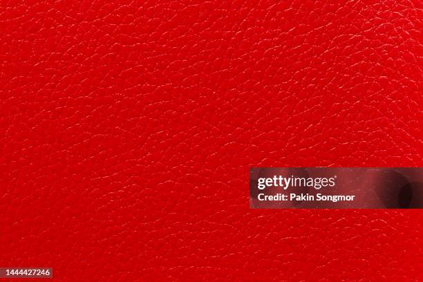 red leather and a textured background. - leather industry stock pictures, royalty-free photos & images