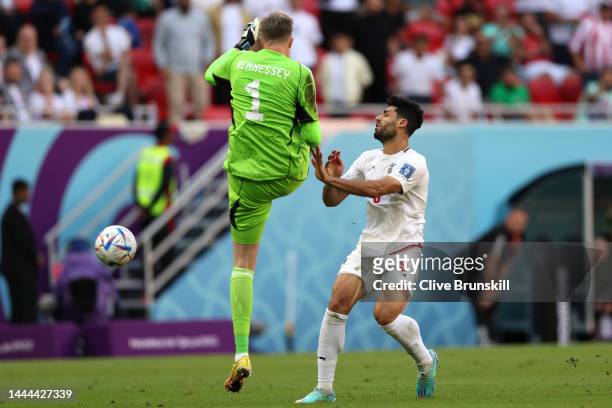 Mehdi Taremi of IR Iran is fouled by Wayne Hennessey of Wales during the FIFA World Cup Qatar 2022 Group B match between Wales and IR Iran at Ahmad...