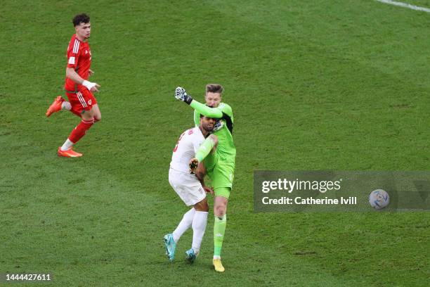 Mehdi Taremi of IR Iran is fouled by Wayne Hennessey of Wales during the FIFA World Cup Qatar 2022 Group B match between Wales and IR Iran at Ahmad...