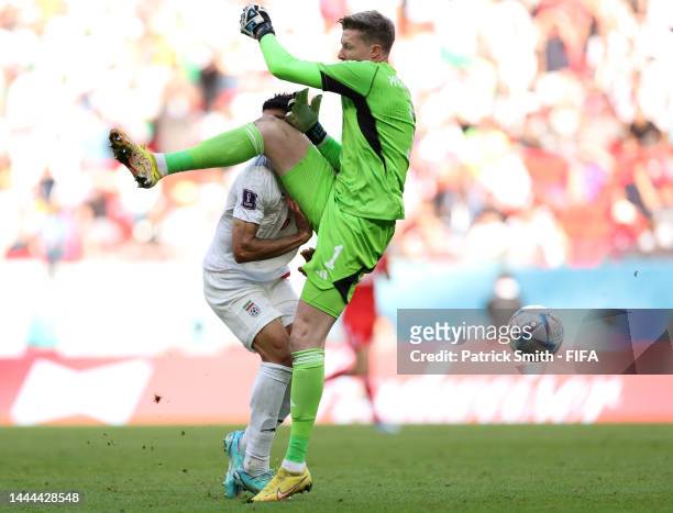 Mehdi Taremi of IR Iran is fouled by Wayne Hennessey of Wales during the FIFA World Cup Qatar 2022 Group B match between Wales and IR Iran at Ahmad...