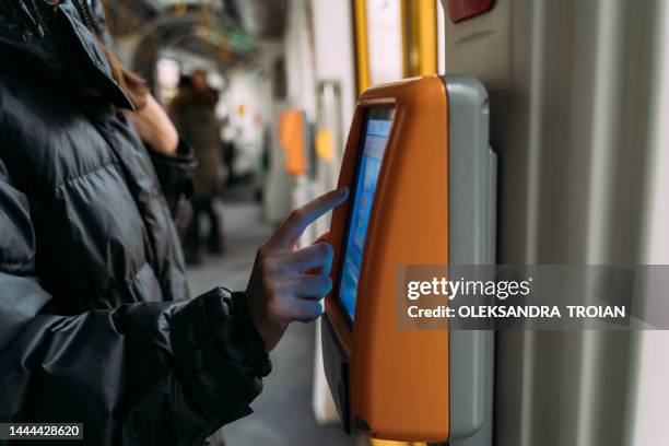 woman using ticket validation machine in tram - electronic document stock pictures, royalty-free photos & images