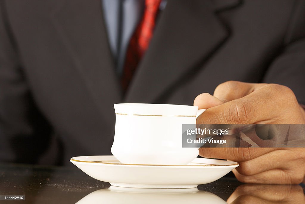 An executive holding a cup
