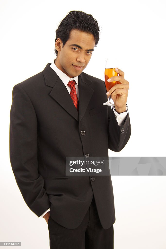 Young business man having a glass of wine