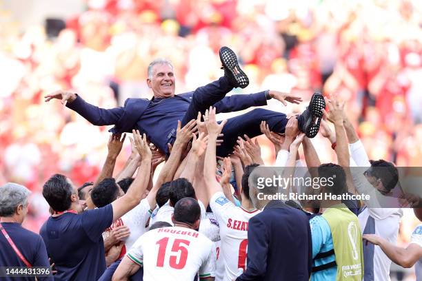 Carlos Queiroz, Head Coach of IR Iran, celebrates with players after the 2-0 win during the FIFA World Cup Qatar 2022 Group B match between Wales and...
