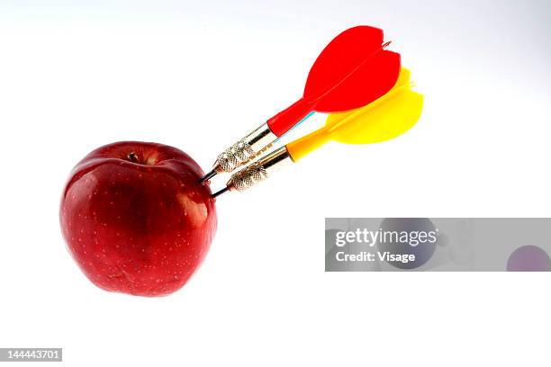 three darts and an apple - piercing stock pictures, royalty-free photos & images
