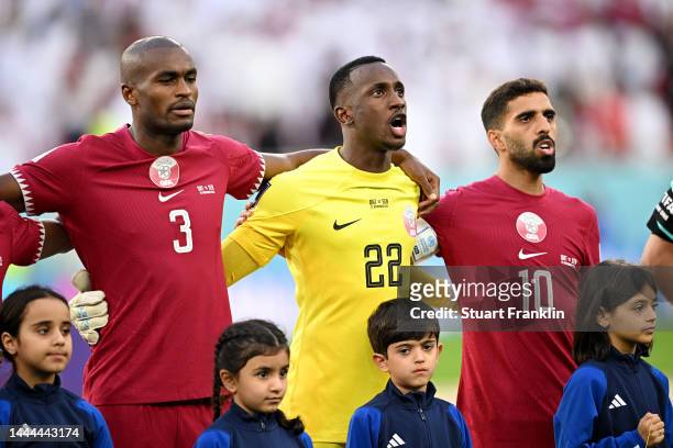 Abdelkarim Hassan, Meshaal Barsham and Hassan Alhaydos of Qatar line up for the national anthem prior to the FIFA World Cup Qatar 2022 Group A match...