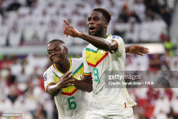 Boulaye Dia of Senegal celebrates with Nampalys Mendy after scoring their team's first goal during the FIFA World Cup Qatar 2022 Group A match...