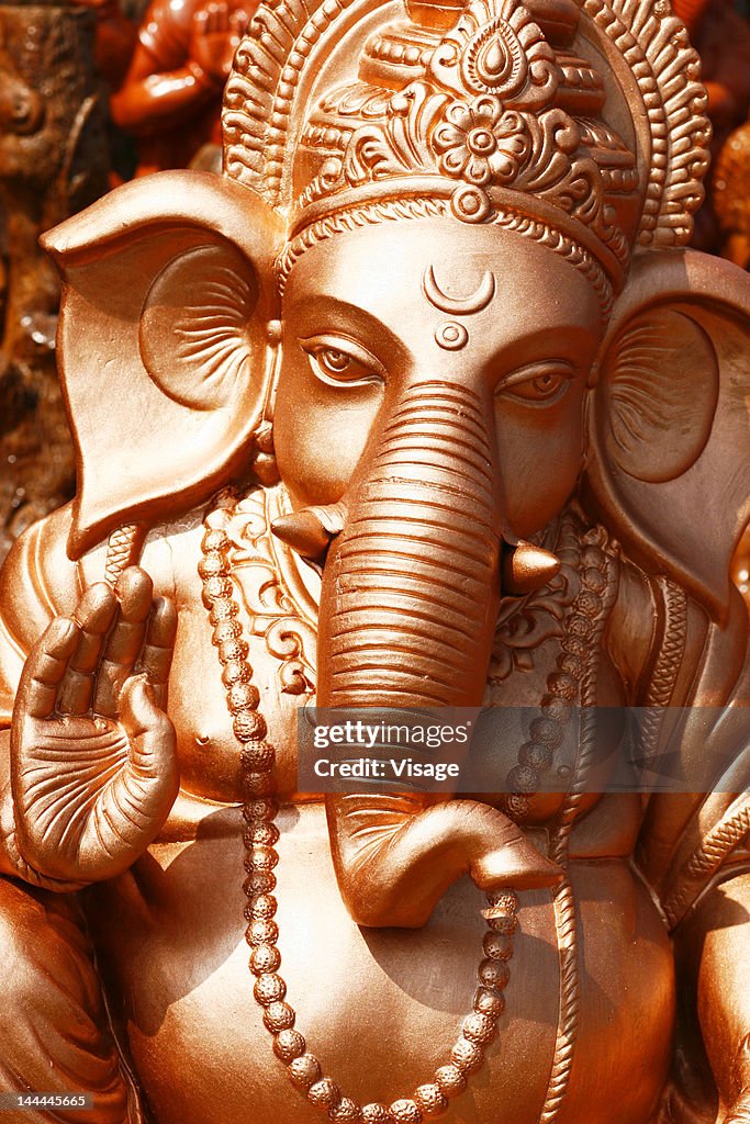 Close up of a painted sculpture of Lord ganesh