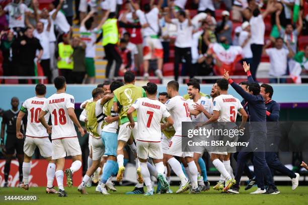 Roozbeh Cheshmi of IR Iran celebrates after scoring his sides first goal with Hossein Hosseini of IR Iran, Milad Mohammadi of IR Iran, Morteza...