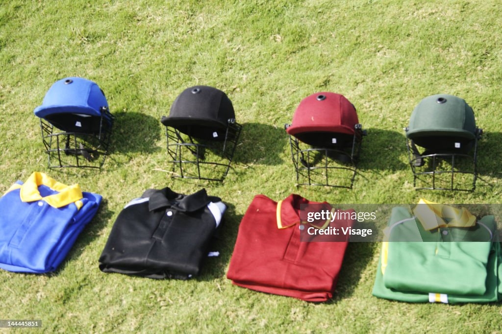 Cricket helmets and jerseys on the ground