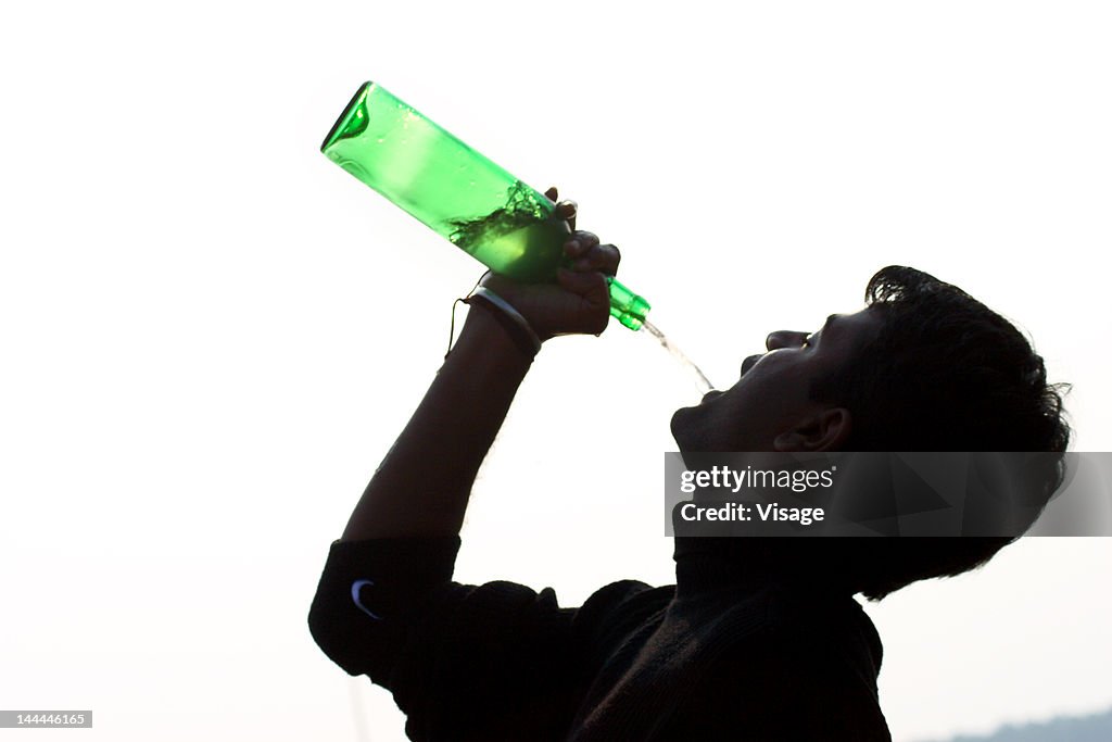 Silhouette of a person drinking alcohol