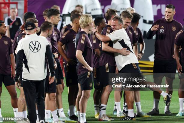Hansi Flick, Head Coach of Germany, interacts with their players during the Germany Training Session at Al Shamal Stadium on November 25, 2022 in Al...