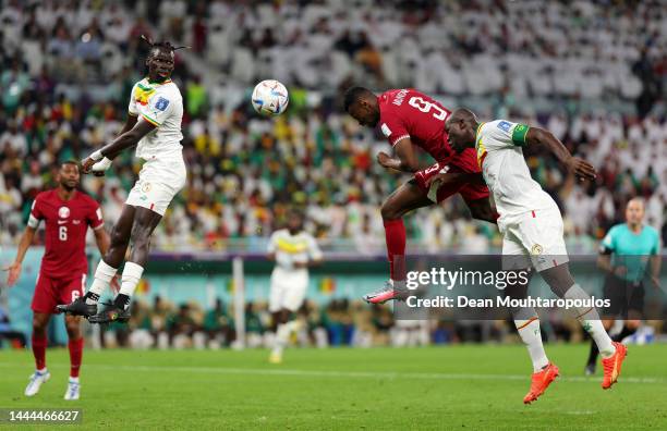 Mohammed Muntari of Qatar heads to score his side's first goal during the FIFA World Cup Qatar 2022 Group A match between Qatar and Senegal at Al...