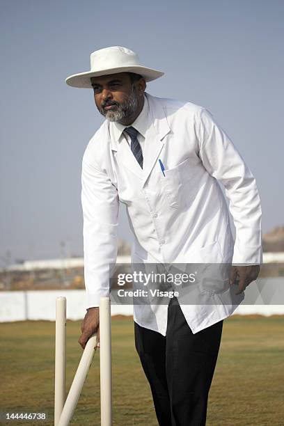 an umpire removing the wicket - cricket umpire stock pictures, royalty-free photos & images