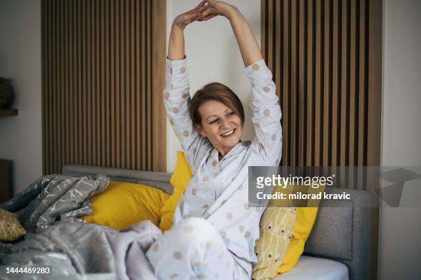 mujer mayor en la cama. - morning bed stretch fotografías e imágenes de stock