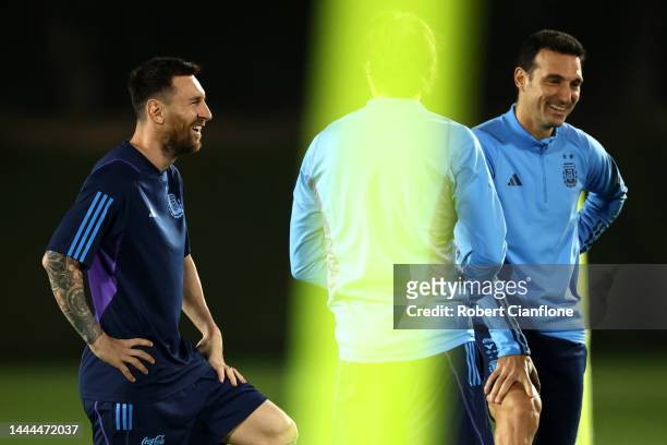 Lionel Messi of Argentina reacts with Lionel Scaloni, Head Coach of Argentina, during the Argentina MD-1 training session at Qatar University on...