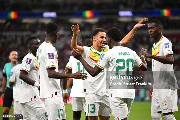 Bamba Dieng of Senegal celebrates with teammates after the 3-1 win during the FIFA World Cup Qatar 2022 Group A match between Qatar and Senegal at Al...