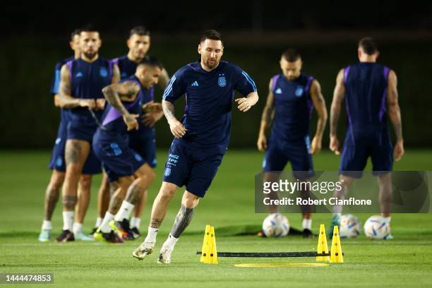 Lionel Messi of Argentina warms up during the Argentina MD-1 training session at Qatar University on November 25, 2022 in Doha, Qatar.