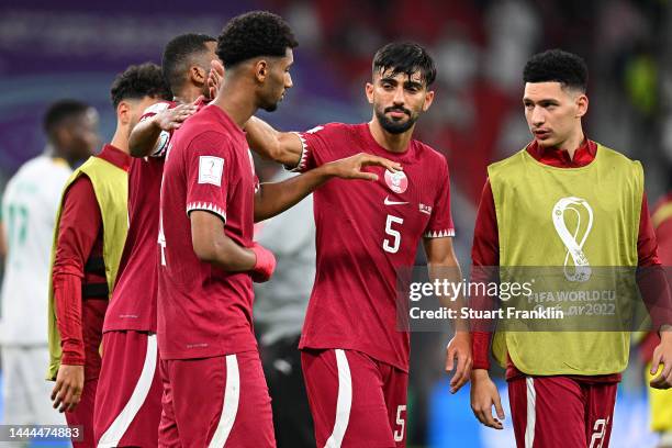 Qatar players show dejection after their 1-3 defeat in the FIFA World Cup Qatar 2022 Group A match between Qatar and Senegal at Al Thumama Stadium on...