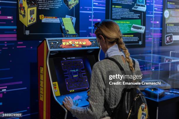 Woman plays a vintage Pac-Man video game during the Milan Games Week & Cartoomics 2022 at Fiera Milano Rho on November 25, 2022 in Milan, Italy....