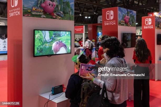 People play video games at the Japanese publisher Nintendo Switch's stand during Milan Games Week & Cartoomics 2022 at Fiera Milano Rho on November...