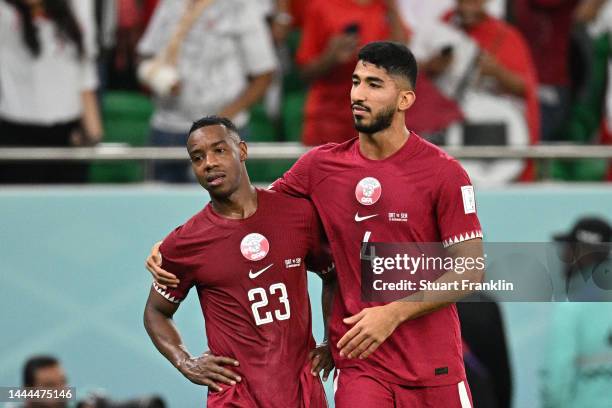 Assim Madibo and Mohammed Waad of Qatar show dejection after their 1-3 defeat in the FIFA World Cup Qatar 2022 Group A match between Qatar and...