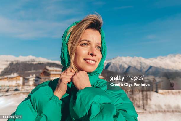 attractive mid age woman enjoys a walk in mountain village - beautiful woman sun stock pictures, royalty-free photos & images