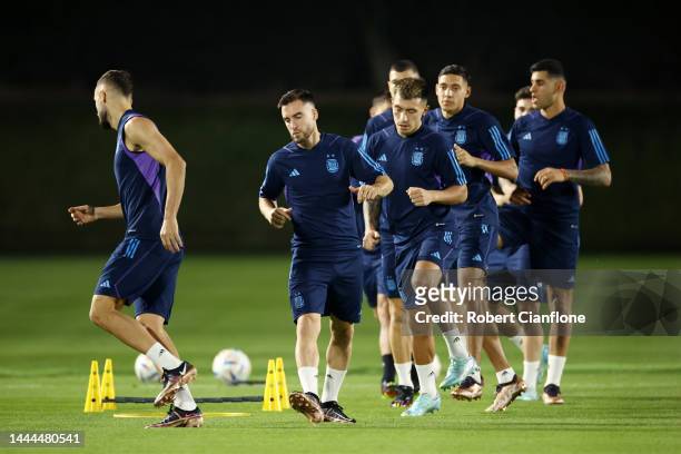 Nicolas Tagliafico and Lisandro Martinez of Argentina warm up during the Argentina MD-1 training session at Qatar University on November 25, 2022 in...