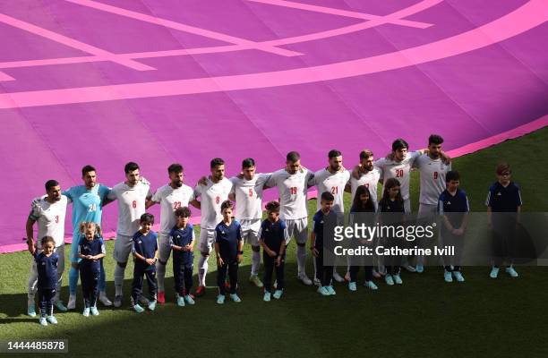The IR Iran team line up for the National Anthem prior to the FIFA World Cup Qatar 2022 Group B match between Wales and IR Iran at Ahmad Bin Ali...